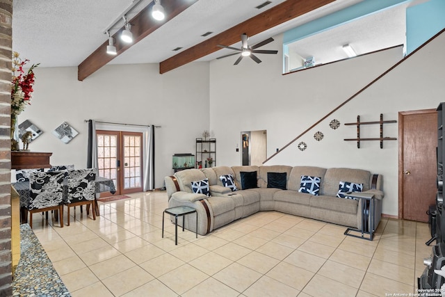 tiled living room featuring high vaulted ceiling, beamed ceiling, ceiling fan, a textured ceiling, and french doors