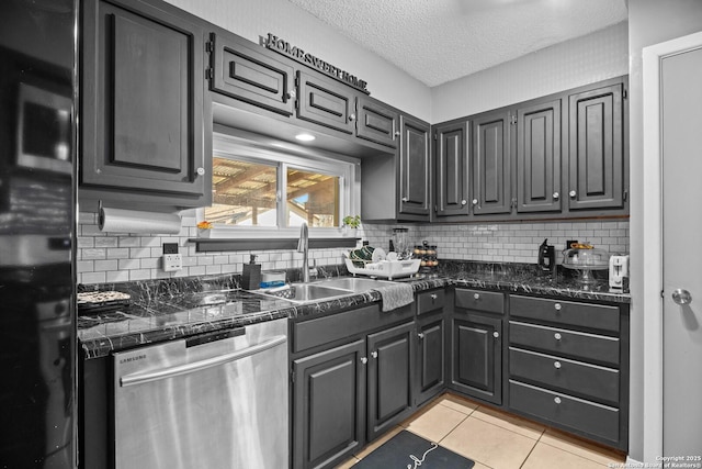 kitchen with light tile patterned flooring, sink, a textured ceiling, fridge, and dishwasher