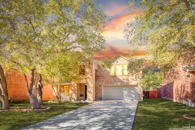 view of front facade with a garage and a lawn