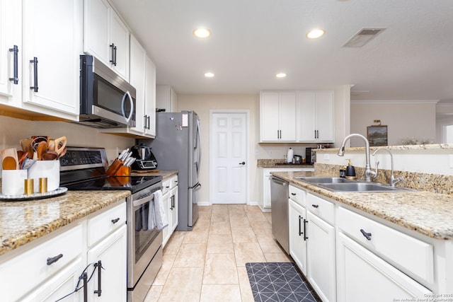 kitchen featuring sink, crown molding, light stone counters, stainless steel appliances, and white cabinets