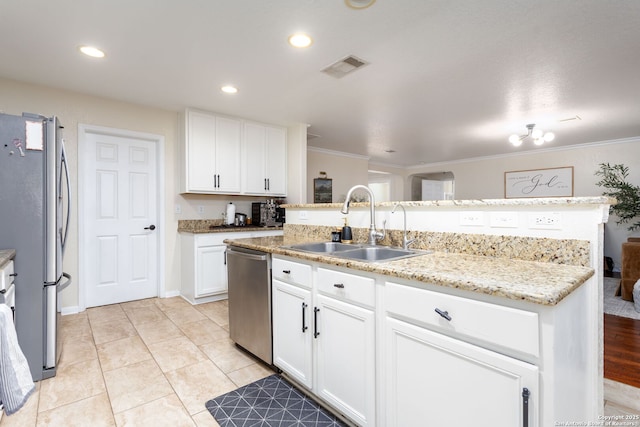 kitchen with sink, stainless steel appliances, light stone countertops, white cabinets, and a center island with sink