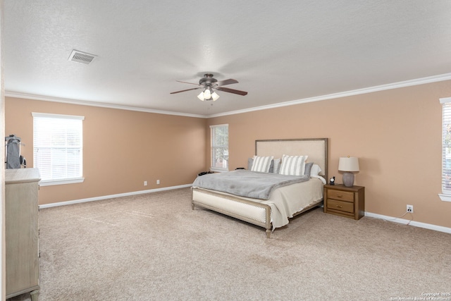 bedroom with a textured ceiling, ornamental molding, ceiling fan, and carpet