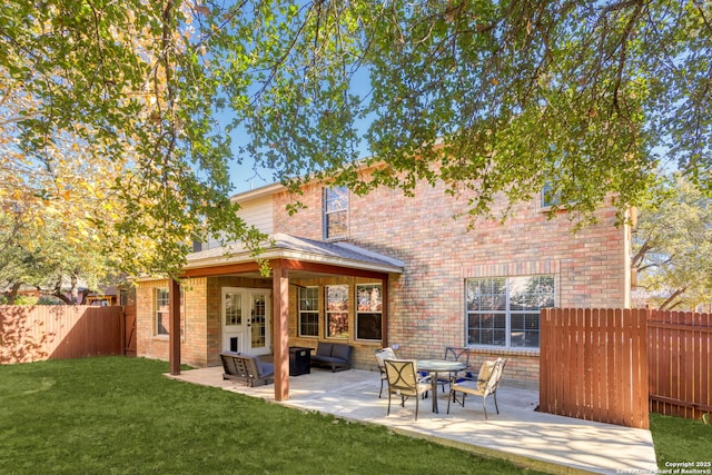 back of property with french doors, a patio area, and a lawn