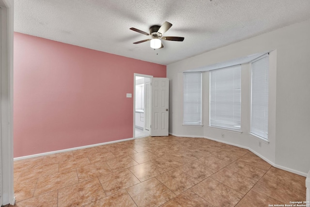 spare room with ceiling fan and a textured ceiling