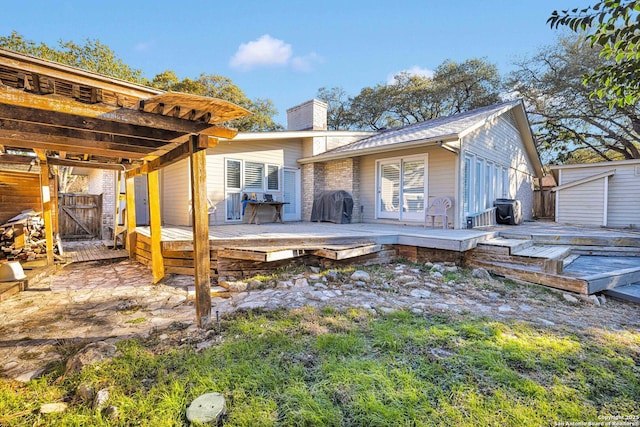 back of house with a wooden deck