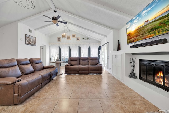 tiled living room featuring lofted ceiling with beams, a textured ceiling, and ceiling fan