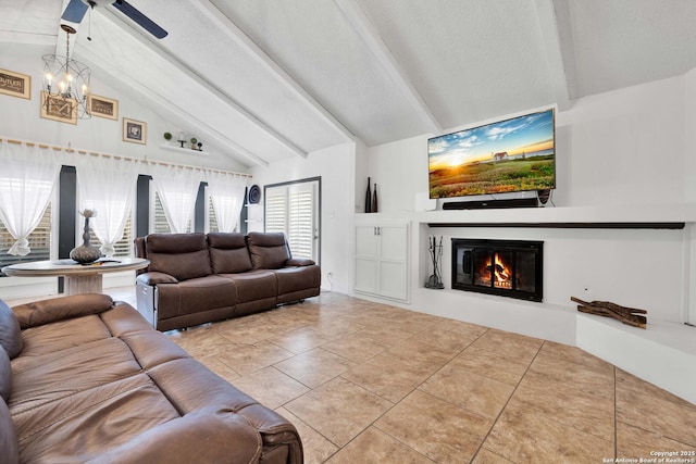 tiled living room with ceiling fan, lofted ceiling with beams, and a textured ceiling