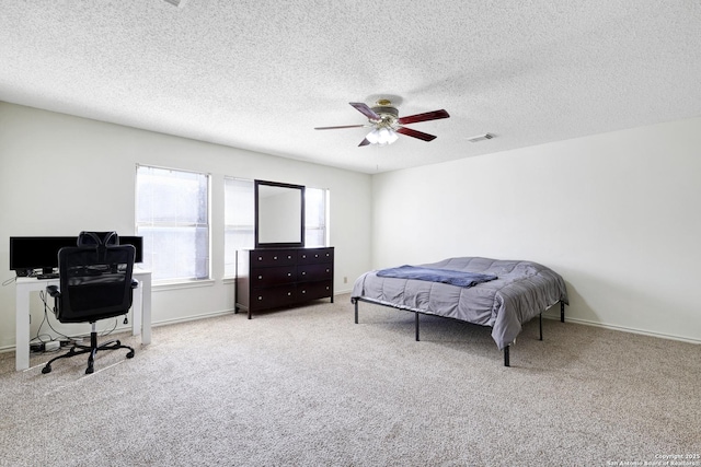 carpeted bedroom with a textured ceiling and ceiling fan