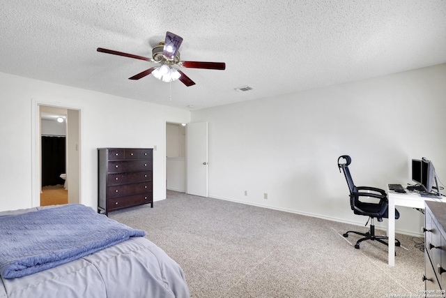 carpeted bedroom featuring ceiling fan and a textured ceiling