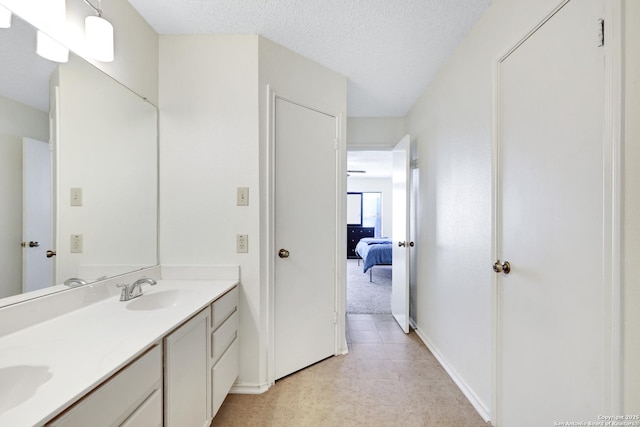 bathroom with vanity and a textured ceiling