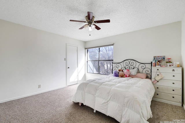 carpeted bedroom featuring a textured ceiling and ceiling fan