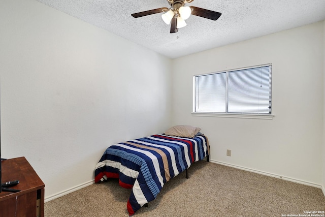 bedroom with ceiling fan, light colored carpet, and a textured ceiling