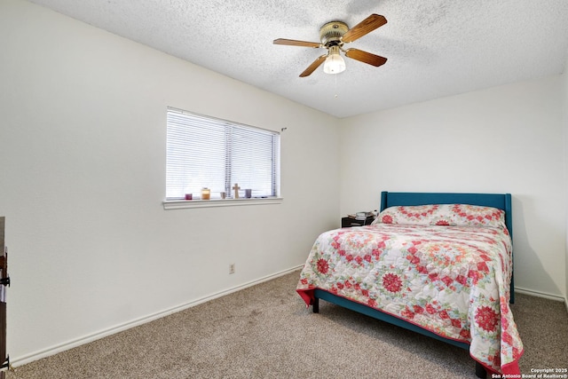 bedroom with a textured ceiling, ceiling fan, and carpet flooring