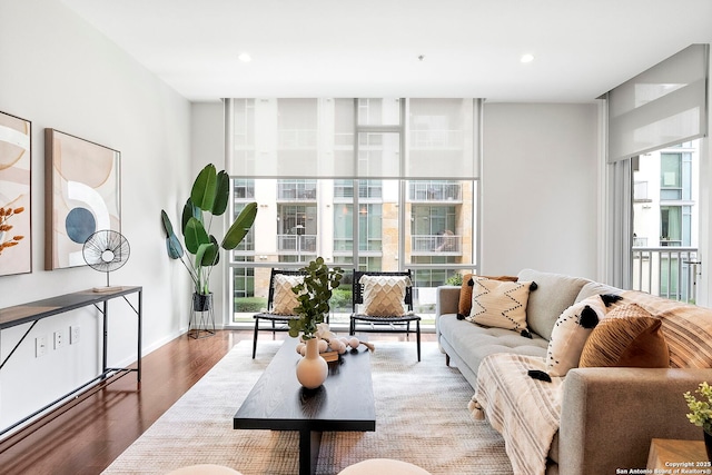 living room featuring hardwood / wood-style flooring, a wealth of natural light, and floor to ceiling windows