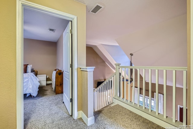 stairs featuring vaulted ceiling and carpet floors