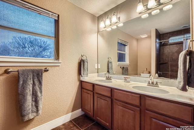 bathroom with vanity, tile patterned floors, and a textured ceiling