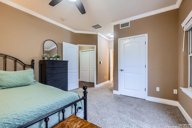 bedroom featuring ornamental molding, a closet, ceiling fan, and carpet flooring