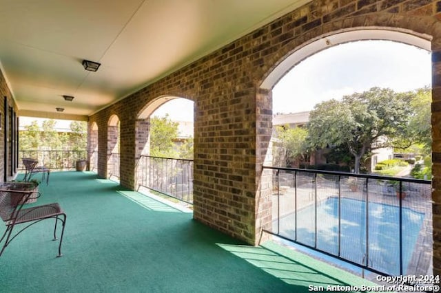 view of patio featuring a balcony