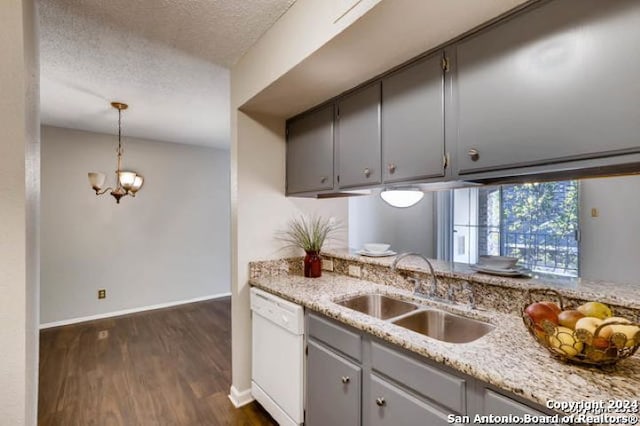 kitchen with sink, a textured ceiling, hanging light fixtures, and dishwasher