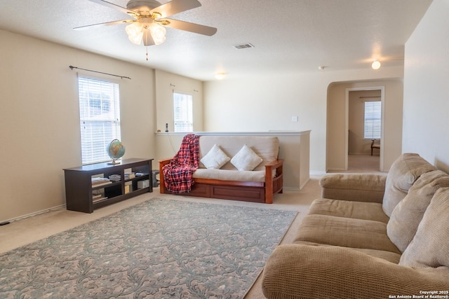 carpeted living room featuring ceiling fan