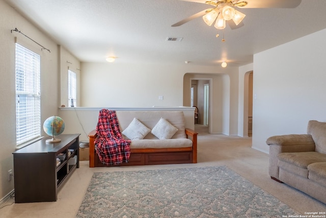 carpeted living room with ceiling fan