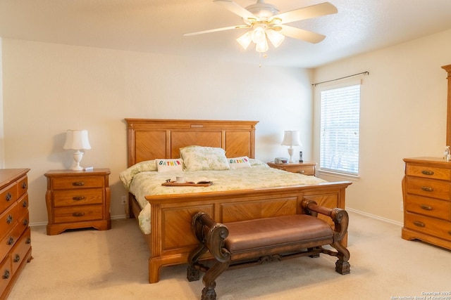 bedroom featuring light carpet and ceiling fan