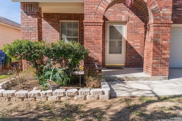 doorway to property with a garage