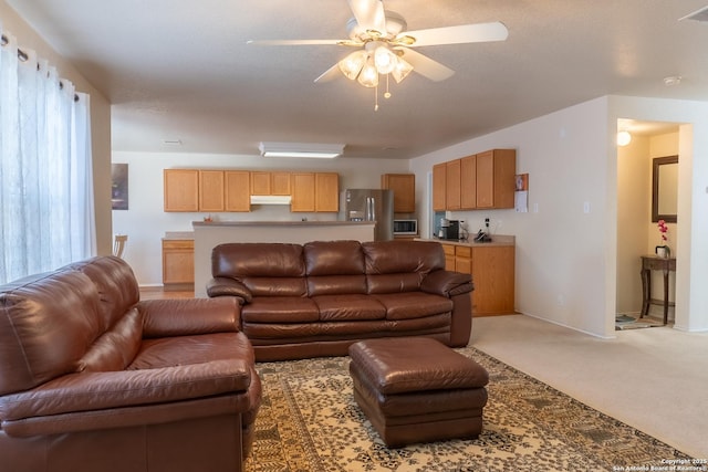 carpeted living room with ceiling fan