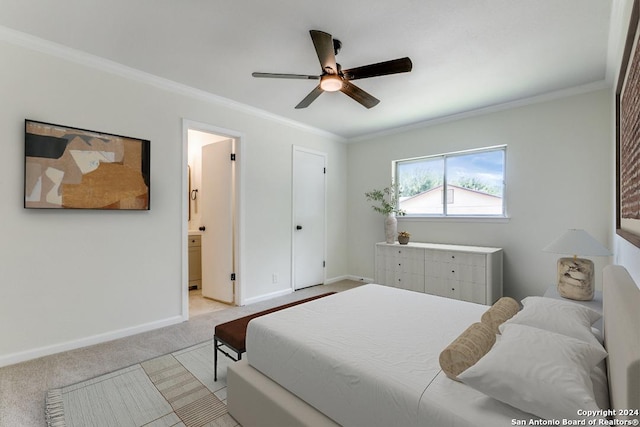 bedroom featuring crown molding, ensuite bath, light colored carpet, and ceiling fan