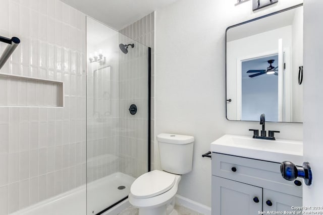 bathroom featuring a shower, vanity, ceiling fan, and toilet