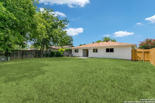 rear view of house with a lawn