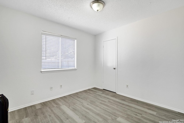 empty room featuring hardwood / wood-style floors and a textured ceiling