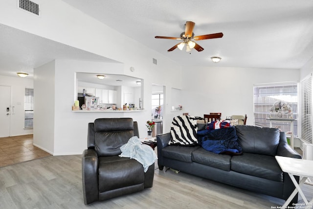 living room featuring light hardwood / wood-style floors and ceiling fan