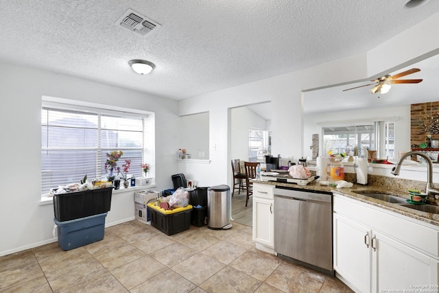 kitchen featuring sink, white cabinetry, a textured ceiling, dishwasher, and light stone countertops