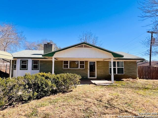 rear view of property featuring a yard and a patio area