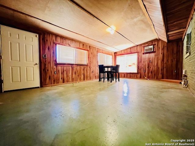 basement featuring brick wall and wood walls