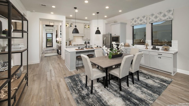 dining area with light hardwood / wood-style flooring