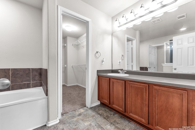 bathroom featuring vanity and a tub to relax in