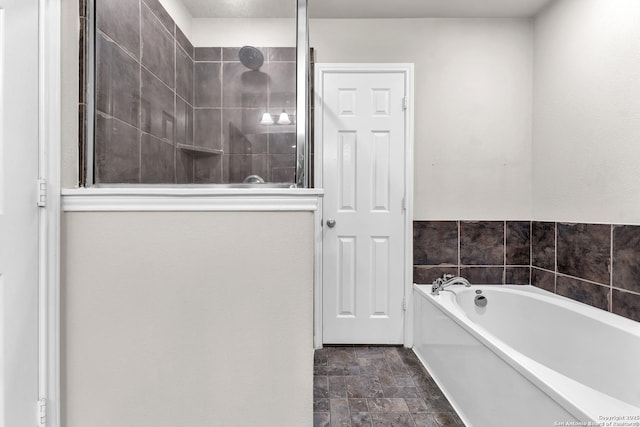 bathroom featuring separate shower and tub