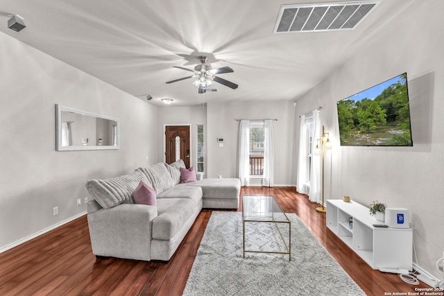 living room featuring dark hardwood / wood-style floors and ceiling fan