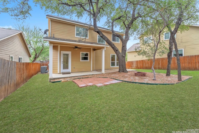 rear view of house with a patio, a yard, central AC, and ceiling fan