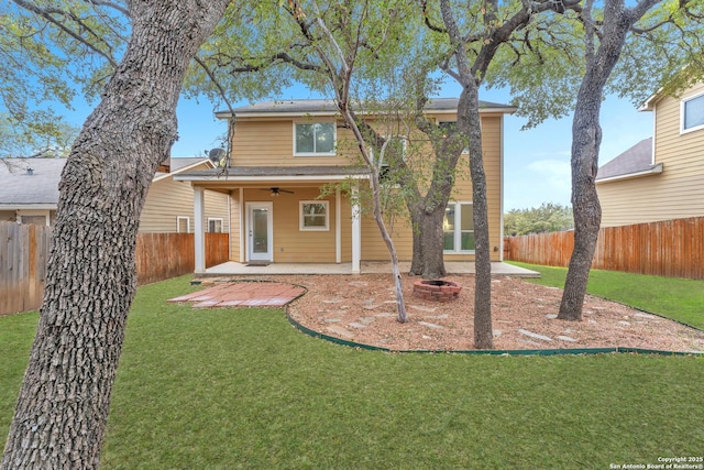 rear view of house featuring a patio area, ceiling fan, and a lawn