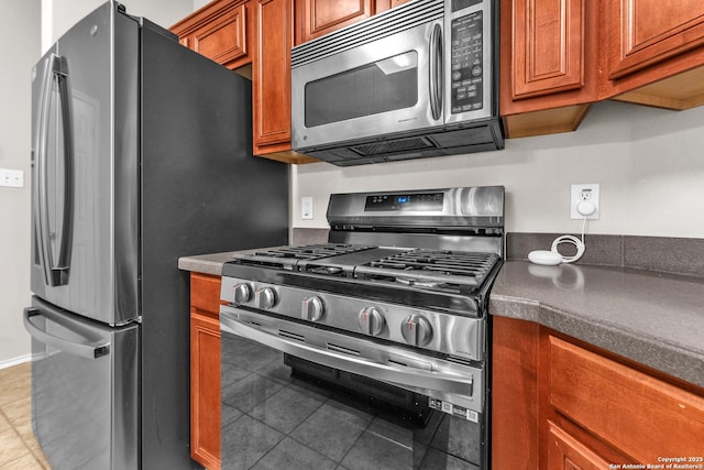 kitchen with appliances with stainless steel finishes and tile patterned floors