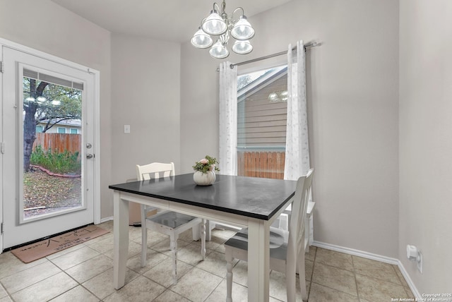 dining room with plenty of natural light, light tile patterned floors, and an inviting chandelier