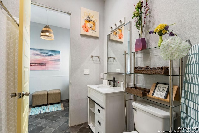 bathroom with tile patterned floors, vanity, and toilet