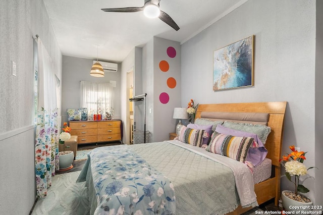 bedroom featuring an AC wall unit and ceiling fan