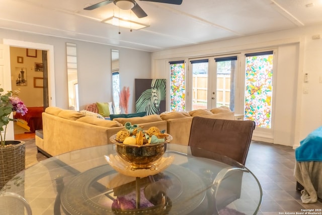 living room featuring ceiling fan and french doors