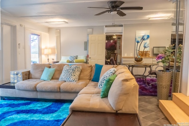 living room with ceiling fan and an AC wall unit