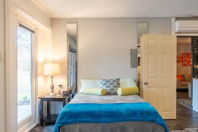 bedroom with a wall mounted air conditioner, electric panel, and dark tile patterned floors