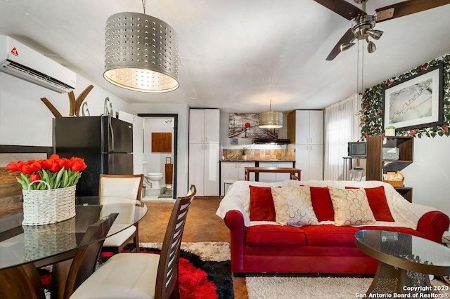 living room with a wall mounted AC, concrete floors, and ceiling fan